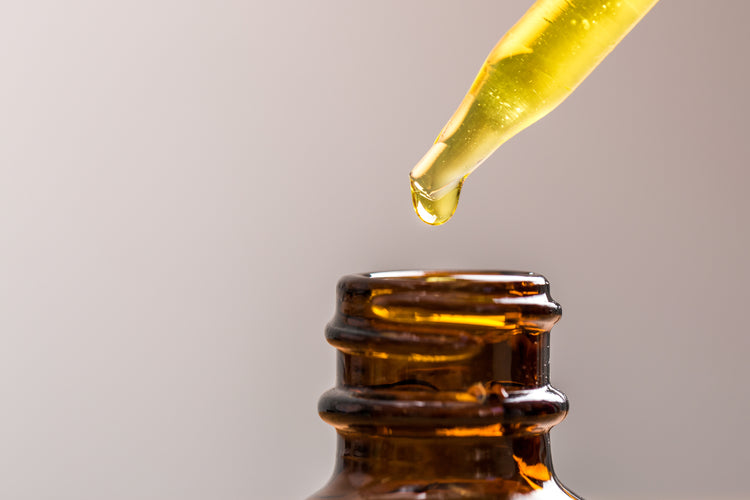 image of essetial oil dripping into a bottle. essential oils are used by green llama