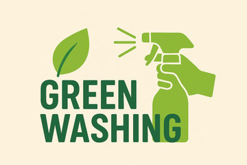 Minimalist blog header illustration with the word 'GREENWASHING' in bold green letters on a cream background, accompanied by a green leaf on the left and a stylized green hand holding a spray bottle on the right.